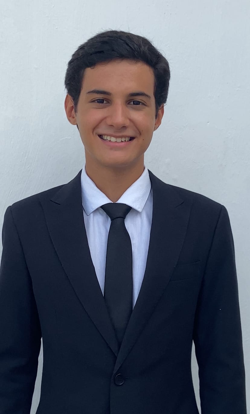 Walter Neto smiling at the camera while wearing a suit